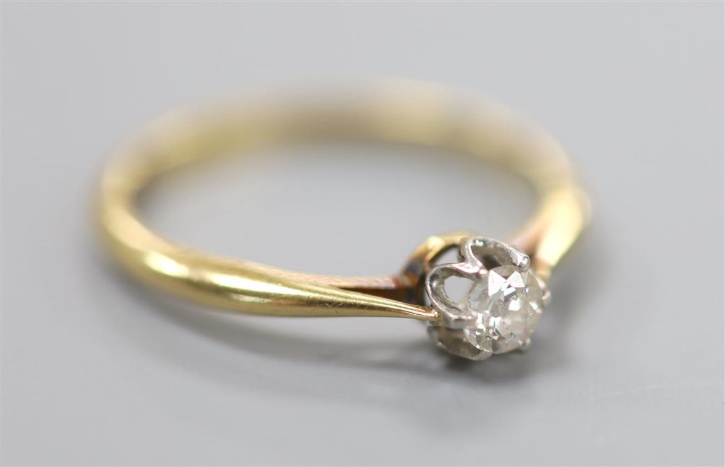 An 18ct and solitaire diamond ring, size Q, gross 2.5 grams, the stone weighing approximately 0.10ct.